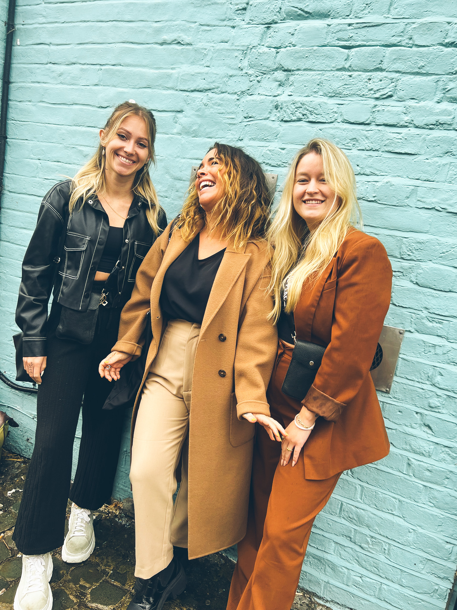 girls hanging out and laughing in front of a salon